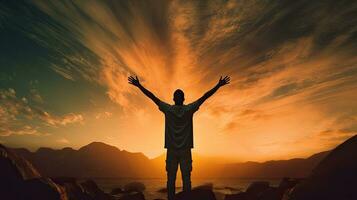 Man s silhouette with raised hands against sunset representing religion faith and devotion photo