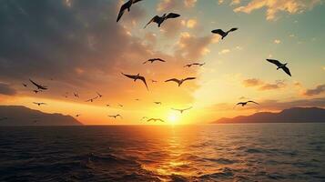 Birds in v shape flying over the sea at sunset symbolizing freedom and the autumn equinox photo