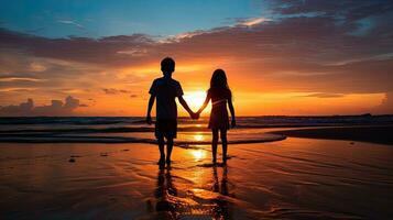Kids silhouette holding hands at sunset on the beach enjoying tranquil moment with stunning colors photo