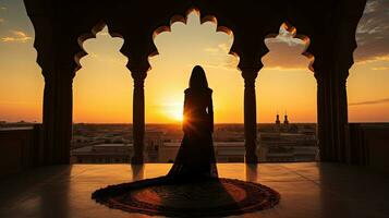 Persian woman in traditional dress against Iranian architecture at sunset in Kashan Iran photo