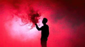 A man with a red smoke stick captured in silhouette photo