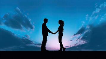 A couple s silhouette of a young pair holding hands against a blue sky backdrop photo