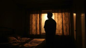 Solitary man gazes at shut window in bedroom photo