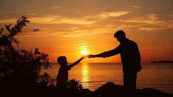 Child and adult hands touch fingers by the sea at sunset photo