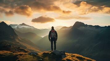 Hiker at sunset on the Langdale pikes in the Lake District photo