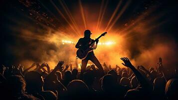 Guitar player performing on stage with crowd in front photo