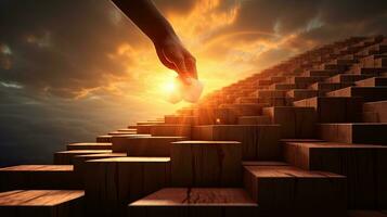 Hand silhouette climbing wooden block stairs with sunlight symbolizing success and achieving goals photo