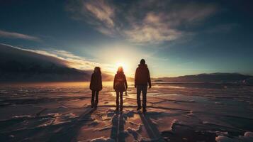 Three people against a frozen lake sky and sun photo