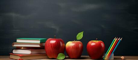 Back to school supplies with apple and empty blackboard photo