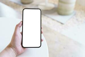 Women's hands holding cell telephone blank copy space screen. smartphone with blank white screen isolated. smart phone with technology concept. photo