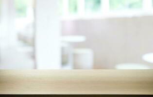 Empty wooden table in front of abstract blurred background of coffee shop . can be used for display or montage your products.Mock up for display of product photo