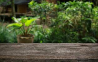 Empty wood table top and blur of out door garden background Empty wooden table space for text marketing promotion. blank wood table copy space photo