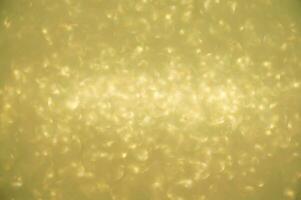 Gold glitters background. shimmering blur spot lights Bokeh Shiny gold light background. photo