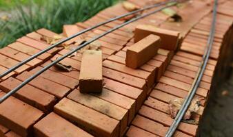 Pallet a red brick building material stack of new red bricks for construction. photo