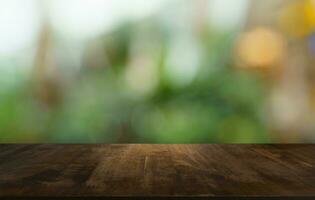 Empty wood table top and blur of out door garden background Empty wooden table space for text marketing promotion. blank wood table copy space for background photo