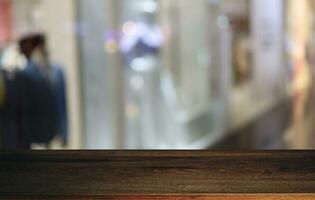 Empty wooden table in front of abstract blurred background of coffee shop . can be used for display or montage your products.Mock up for display of product photo