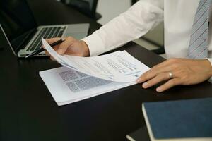 Examiner reading a resume during job interview at office Business and human resources concept. photo