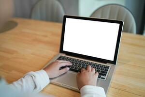 Woman Working by using laptop blank screen computer . Hands typing on a keyboard.technology e-commerce concept. photo