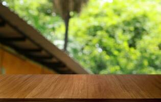 Empty wooden table in front of abstract blurred background of coffee shop . can be used for display or montage your products.Mock up for display of product photo