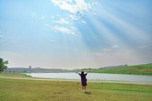 Carefree happy woman in morning of nature cliff mountain. Woman travel tourist alone morning freedom and happiness. photo