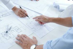 Colleagues interior designer Corporate Achievement Planning Design on blueprint Teamwork Concept with compasse. photo