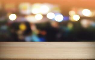 Empty dark wooden table in front of abstract blurred bokeh background of restaurant . can be used for display or montage your products.Mock up for space. photo