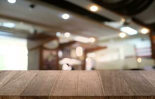 Empty dark wooden table in front of abstract blurred bokeh background of restaurant . can be used for display or montage your products.Mock up for space. photo