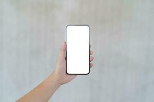 Women's hands holding cell telephone blank copy space screen. smartphone with blank white screen isolated. smart phone with technology concept. photo