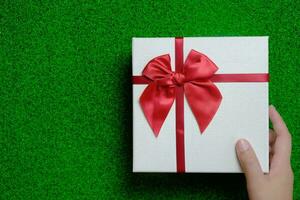 Happy New Year present. Gift box and red ribbon for Christmas. photo