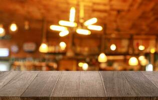 Empty wooden table in front of abstract blurred background of coffee shop . can be used for display or montage your products.Mock up for display of product photo