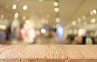 Wood table top in front of abstract blurred background. Empty wooden table space for text marketing promotion. blank wood table surface copy space photo