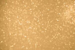 Gold glitters background. shimmering blur spot lights Bokeh Shiny gold light background. photo