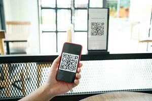 Qr code payment. E wallet. Man scanning tag accepted generate digital pay without money.scanning QR code online shopping cashless payment and verification technology concept photo