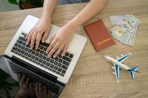 Woman booking tickets online. searching buying booking flights ticket airlines or hotel Travel and tourism agency concept photo
