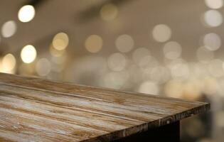 Empty wooden table in front of abstract blurred background of coffee shop . can be used for display or montage your products.Mock up for display of product photo