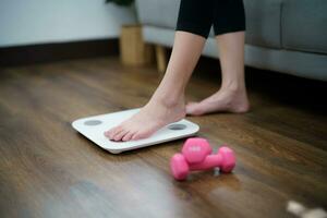 Fat diet and scale feet standing on electronic scales for weight control. Measurement instrument in kilogram for a diet control photo