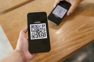 Qr code payment. E wallet. Man scanning tag accepted generate digital pay without money.scanning QR code online shopping cashless payment and verification technology concept. photo