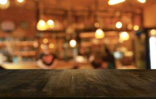 Empty wooden table in front of abstract blurred background of coffee shop . can be used for display or montage your products.Mock up for display of product photo