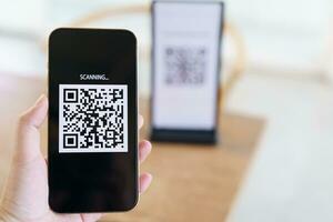 Qr code payment. E wallet. Man scanning tag accepted generate digital pay without money.scanning QR code online shopping cashless payment and verification technology concept. photo