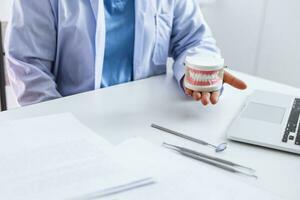 Dentist examining a patient teeth medical treatment at the dental clinic. photo