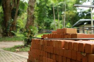 Pallet a red brick building material stack of new red bricks for construction. photo