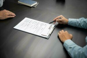 Examiner reading a resume during job interview at office Business and human resources concept. photo