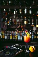 Cocktail alcoholic drink with Classic bar counter with bottles in blurred liquor bar background photo