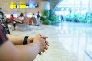 Man waiting for flight in airport departure area at airport waiting the flight photo