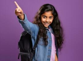 Cheerful girl in school uniform pointing finger up photo