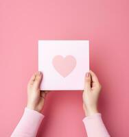 Woman holding pink heart card photo