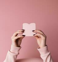 Woman holding pink heart card photo