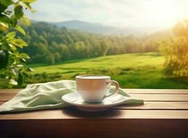 té en taza en un de madera mesa con verde campo en el antecedentes foto