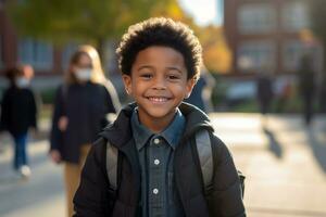 A happy child in black walking into school photo