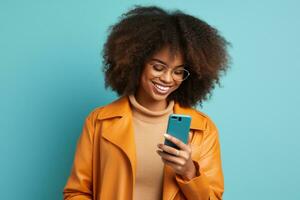 Woman with curly hair is using her smartphone and smiling photo